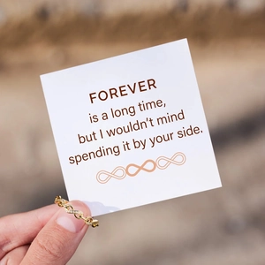 Detailed view of infinity symbol ring in 18K gold with crystals and a romantic gift card