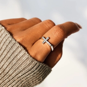 Elegant S925 sterling silver cross ring with sparkling zircon stones on a model hand