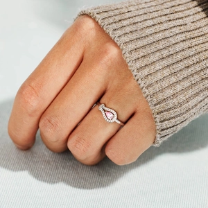 Detailed view of an S925 silver ring featuring a pink pear-cut stone and pavé accents