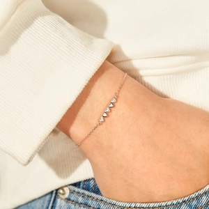 Elegant S925 sterling silver heart bracelet with sparkling zircon charms on female wrist