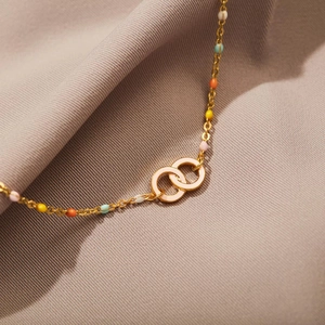 Detail of s925 silver gold chain with enamel double rings and colorful beads decoration