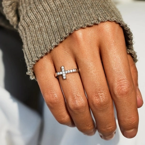 Elegant S925 sterling silver cross ring with pavé zircons worn on hand against a sweater