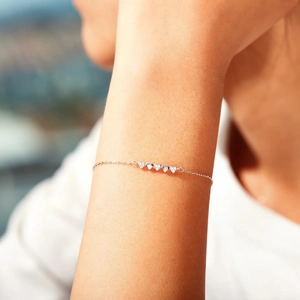 Elegant S925 sterling silver heart bracelet with cubic zirconia on a female wrist