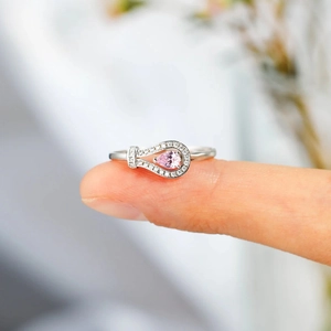 Detailed close-up of S925 silver ring featuring a pink pear-shaped stone and micro-pavé setting