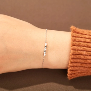 Close-up of s925 silver heart bracelet with zircon stones on a model's wrist