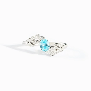 Minimalist s925 silver ring featuring blue oval gemstone and sparkling leaf vine design