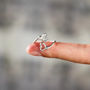 Close-up of S925 sterling silver double heart open ring with intricate twisted details