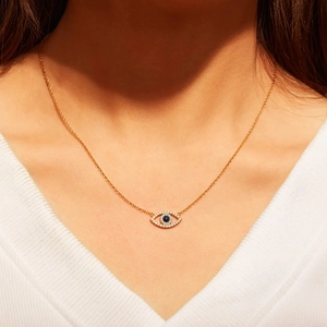 S925 sterling silver gold evil eye necklace with blue zircon stones on a model