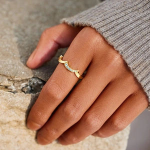 Minimalist S925 silver crown wave ring with blue topaz stones on woman's finger