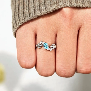 Minimalist S925 sterling silver ring featuring oval blue stone and leaf accents