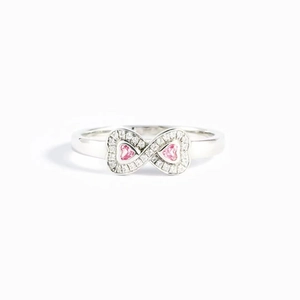 Detailed macro view of an infinity ring with pink heart stones and pavé cubic zirconia