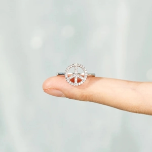 Macro detail of s925 silver peace sign ring with shimmering pavé cubic zirconia