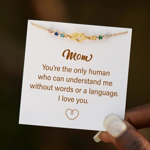 Detail of gold heart infinity necklace with multi-colored gemstones and mother's gift card