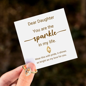 Detailed view of marquise champagne zircon ring with a mother and daughter message card