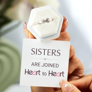 Close-up of S925 silver infinity heart ring with pink stones in a velvet gift box