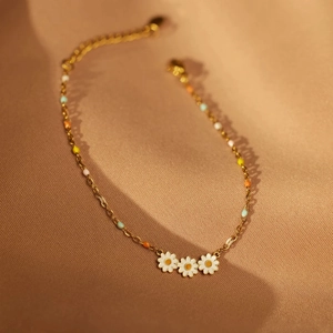 Golden S925 silver bracelet with white enamel daisies and colorful macaron beads