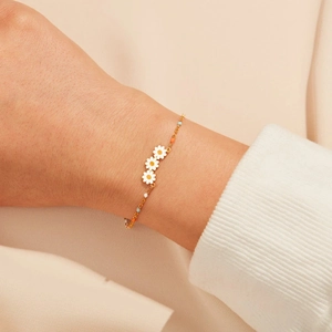 Detail of s925 silver daisy bracelet with enamel flowers and colorful beads on a wrist