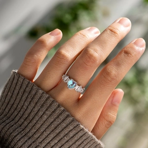 Elegant S925 silver ring featuring a blue heart gemstone and baguette zircon accents