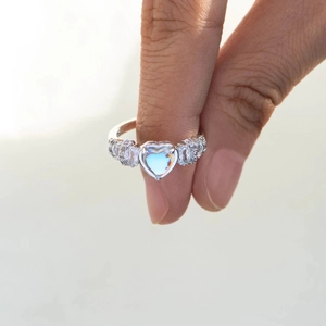 Macro detail of S925 silver heart ring with colorful zircon and blue sheen moonstone