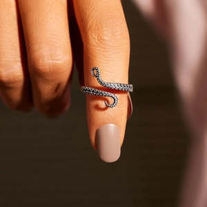 Macro shot of s925 silver octopus tentacle ring with realistic sucker textures and details