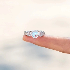 Macro shot of s925 silver ring featuring a heart moonstone on a finger display