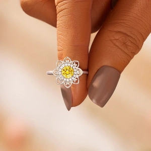 Macro shot of S925 sterling silver mandala ring with a central yellow round cut stone