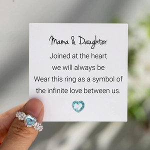 Macro view of S925 silver heart ring with blue zircon beside an emotional message card
