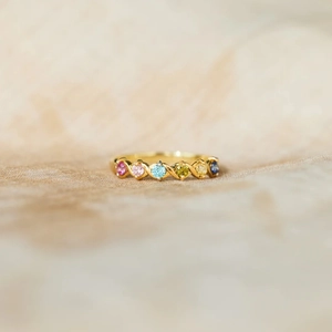 Detail of s925 silver ring with 6 multi-color birthstones and golden twisted band