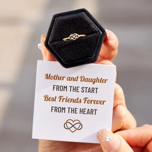Detail of gold infinity heart ring with mother and daughter gift card in a box