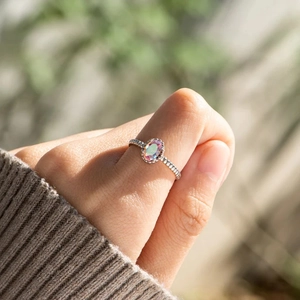 Détail d'une bague en argent s925 avec pierre ovale dégradée et anneau perlé au doigt