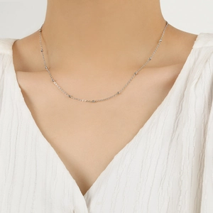 Minimalist S925 sterling silver beaded choker necklace worn on a woman's collarbone