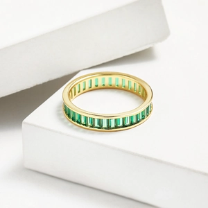 Detailed macro view of gold plated S925 silver ring set with emerald green zircon stones