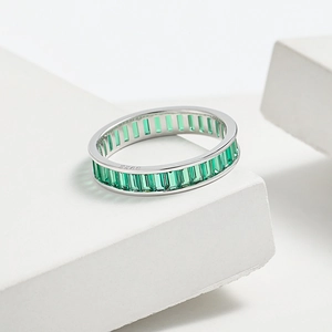 Detailed macro view of S925 sterling silver ring with green emerald-cut zircon stones