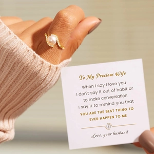 Macro shot of s925 gold bypass ring with round pearl and zircon pavé near a gift card