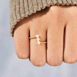 Elegant gold plated S925 silver ring featuring three pearls and pave set zirconia stones