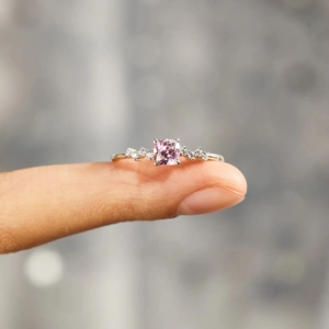 Macro shot of s925 silver ring with cushion cut pink stone and side diamonds