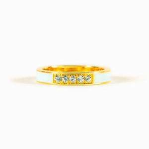 Minimalist gold ring with light blue enamel and five sparkling zircons on a white background