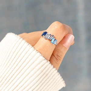 S925 sterling silver ring featuring baguette-cut gradient blue stones worn on finger