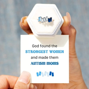 Close-up of S925 silver ring with five blue rectangular zircons in a white velvet box