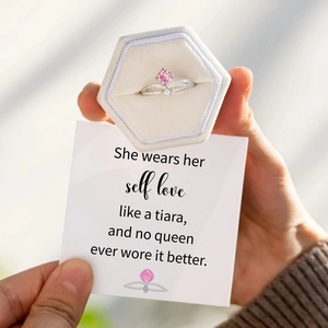 Pink princess cut stone crown ring in a white velvet box with a gift card