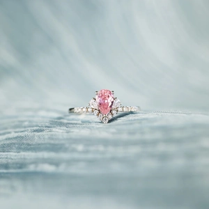 Elegant S925 silver crown ring with pear-cut pink gemstone and diamond-accented band