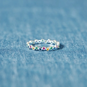 Minimalist s925 silver rainbow gemstone ring featuring colorful stones on denim background