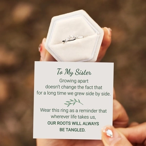 Close-up of S925 sterling silver knot ring with a hex jewelry box and sister gift card