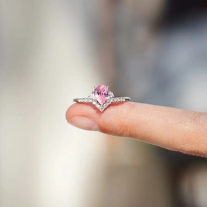 Detailed macro view of an S925 silver V-shaped ring featuring a pear-cut pink gemstone