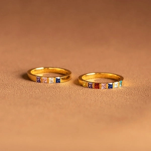 Minimalist gold S925 silver rings with square-cut colorful birthstones on brown backdrop