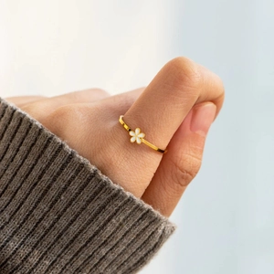 Minimalist S925 sterling silver ring with white enamel flower on female index finger