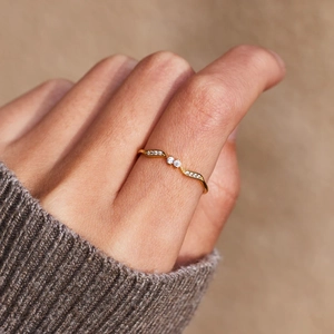 Elegant s925 silver wave ring with double stones worn over a grey knit sweater sleeve