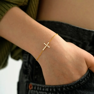 Elegant s925 silver gold-plated cross bracelet with sparkling cubic zirconia on a model