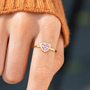 Macro shot of gold s925 ring with pink heart stone and matching enamel inlay
