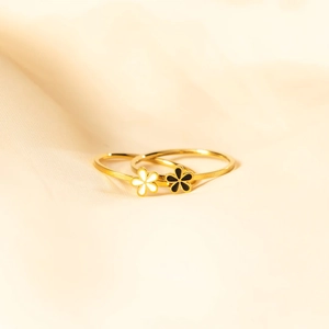 Detail of s925 silver flower rings with black and white enamel in a gold finish